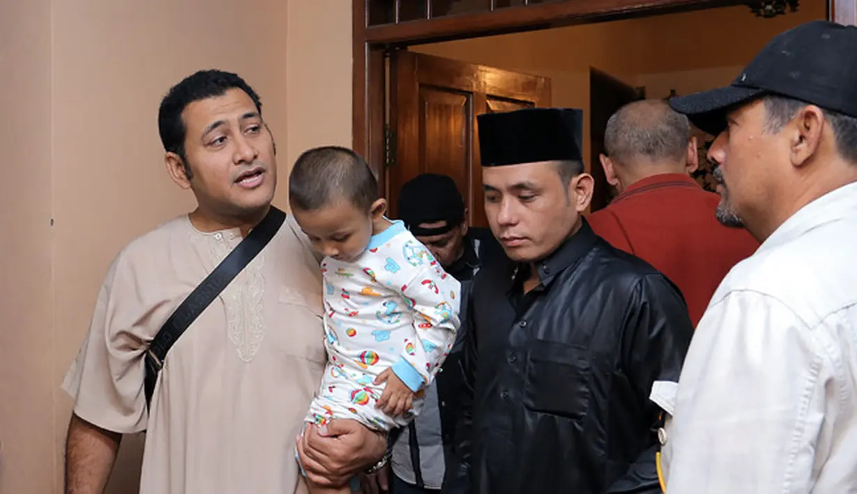 Sejak di rumah duka, Said Bajuri memang tampak sudah ikhlas melepas kepergian sang istri. Ia terus menggendong sang buah hati berada di dekapannya sambil menemani jenazah Alyah di kediamannya tadi malam. (Deki Prayoga/Bintang.com)