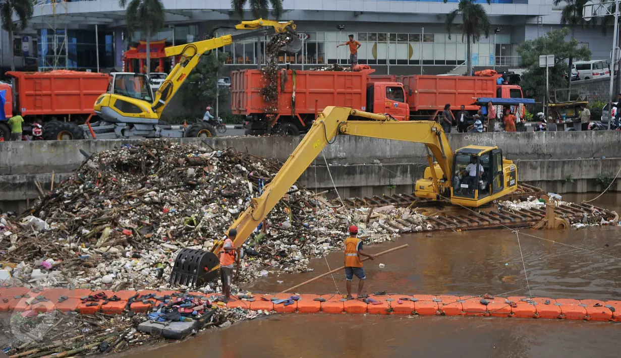 Petugas dibantu alat berat membersihkan sampah yang menumpuk di Kali Angke, Jakarta, Kamis (3/2). Ini dilakukan sebagai salah satu upaya mengantisipasi banjir di Ibu Kota saat musim hujan. (Liputan6.com/Gempur M Surya)  
