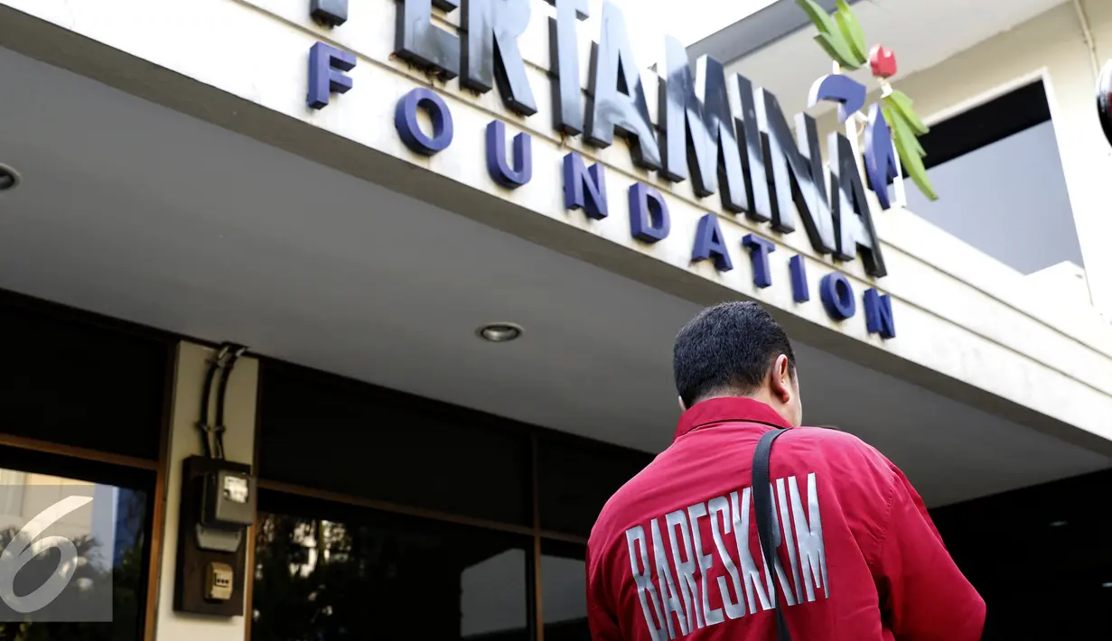 Polisi berjaga di depan salah satu ruangan Pertamina Foundation yang sedang digeledah penyidik, Jakarta, Senin (1/9/2015). Pertamina Foundation digeledah terkait dugaan penyalahgunaan anggaran program tahun 2013 hingga 2014. (Liputan6.com/Yoppy Renato)
