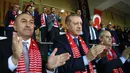 Presiden Turki, Tayyip Erdogan, memberikan tepuk tangan saat Timnas Turki berhasil membobol gawang Finlandia. Namun kemenangan ini masih belum cukup untuk mengangkat posisi Turki dari posisi empat Grup I. (AFP/Kayhan Ozer)