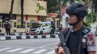 Polisi bersenjata berjaga di sekitar Mapolda Riau, Rabu (16/5). Sekelompok terduga teroris menyerang Mapolda Riau sambil membawa senjata tajam. (WAHYUDI/AFP)