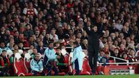 Manajer Arsenal asal Spanyol, Mikel Arteta, memberikan instruksi kepada para pemain dari pinggir lapangan selama pertandingan leg pertama perempat final Liga Champions UEFA antara Arsenal dan Real Madrid, di Stadion Emirates, London, Rabu dini hari WIB (9-4-2025). (Adrian Dennis/AFP)