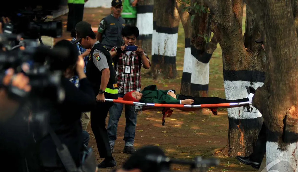 Seorang mahasiswi terpaksa ditandu dari lapangan upacara karena pingsan, Jakarta, Rabu (1/10/2014) (Liputan6.com/Johan Tallo)