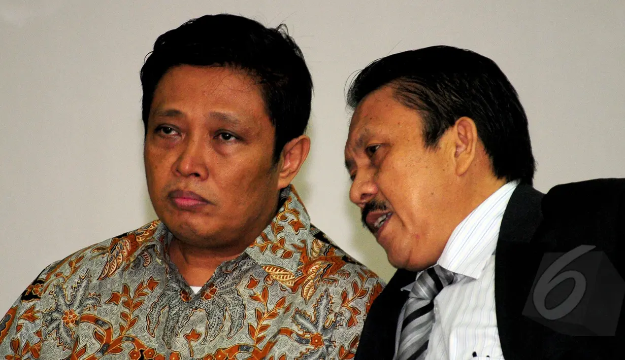 Machfud Suroso berdiskusi dengan penasihat hukumnya saat pembacaan vonis oleh majelis hakim di Pengadilan Tipikor, Jakarta, Rabu (1/4/2015). Machfud dianggap melakukan tindak pidana korupsi dalam proyek P3SON Hambalang. (Liputan6.com/Yoppy Renato)