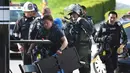 Personel LAPD Hazmat dan Bomb Squads  mempersiapkan diri untuk menyelidiki sebuah paket mencurigakan yang ditemukan di ruang surat di kantor Deutsche Bank di Los Angeles, California, Rabu (19/8/2015). (AFP/MARK RALSTON)