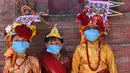 Anak-anak Nepal mengenakan masker dan kostum sapi tradisional saat berpartisipasi dalam prosesi 'Gai Jatra', atau festival sapi, di Kathmandu, Selasa (4/8/2020). Festival ini untuk meminta keselamatan dan kedamaian bagi orang yang mereka cintai yang telah meninggal. (PRAKASH MATHEMA/AFP)