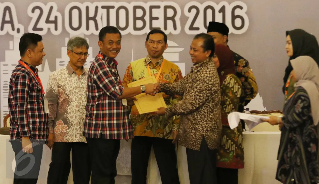 Ketua tim pemenangan Ahok-Djarot, Prasetio Edi Marsudi menerima berkas penetepan Cagub dan Cawagub DKI Jakarta dari Ketua KPUD DKI Sumarno saat rapat pleno terbuka penetapan Cagub dan Cawagub DKI Jakarta, Senin (24/10). (Liputan6.com/Immanuel Antonius)