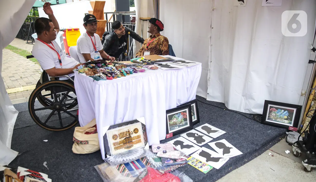 Penyandang disabilitas menjaga booth pada acara puncak peringatan Hari Disabilitas Internasional 2019 di Plaza Barat Gelora Bung Karno, Jakarta, Selasa (3/12/2019). Acara ini berlangsung pada tanggal 2-3 Desember 2019. (Liputan6.com/Faizal Fanani)