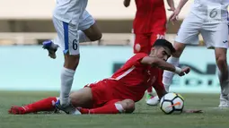 Pemain belakang Bahrain, Husain Sabba terjatuh saat menahan serangan pemain Uzbekistan saat laga PSSI Anniversary Cup 2018 di Stadion Pakansari, Kab Bogor, Senin (30/4). Laga berakhir imbang 3-3. (Liputan6.com/Helmi Fithriansyah)