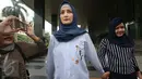 Aktris Inneke Koesherawati ditemani seorang kerabatnya usai mendatangi Gedung KPK, Jakarta, Kamis (29/12). Inneke Koesherawati datang untuk meminta izin menjenguk suaminya, Fahmi Darmawansyah yang ditahan di Rutan Guntur. (Liputan6.com/Helmi Afandi)