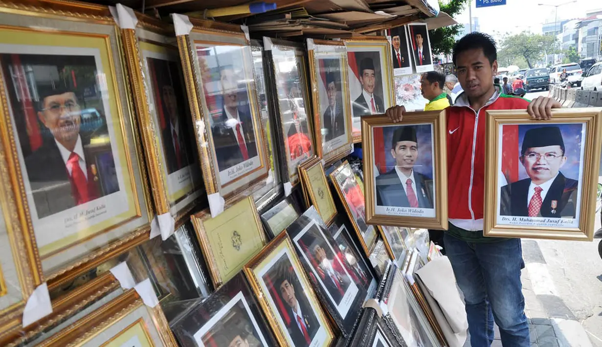 Pedagang foto resmi kenegaraan Presiden Joko Widodo atau Jokowi dan Wakil Presiden Jusuf Kalla di kawasan Pasar Baru, Jakarta, Sabtu (25/10/2014). (Liputan6.com/Miftahul Hayat)