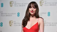 Aktris AS, Dakota Johnson ketika menghadiri ajang penghargaan British Academy of Film and Television Arts (BAFTA) 2016 di London, Minggu (14/2). Nominator kategori Rising Star itu tampil dalam balutan gaun merah berbelahan dada rendah. (AFP/Ben STANSALL)