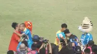 Kapten tim Persib Bandung Supardi Nasir dan kapten tim Semen Padang Dedy Gusmawan membagikan bunga kepada kedua suporter. (Liputan6.com/Huyogo Simbolon)