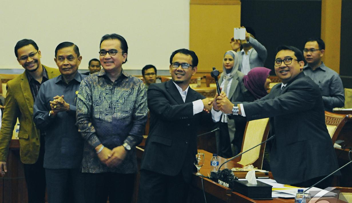 Fadli Zon (kanan) memberikan palu sidang kepada Ketua Komisi I terpilih Mahfudz Siddiq (kedua kanan), Jakarta, Rabu (29/10/2014) (Liputan6.com/Andrian M Tunay)