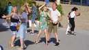 Orang-orang menari mengikuti musik di luar sebuah bar di Madrid, Spanyol, Minggu (19/6/2022). Sebelumnya Spanyol dilanda gelombang panas yang bergerak ke utara melalui Eropa dengan suhu bisa mencapai di 43 derajat Celcius. (AP Photo/Paul White)