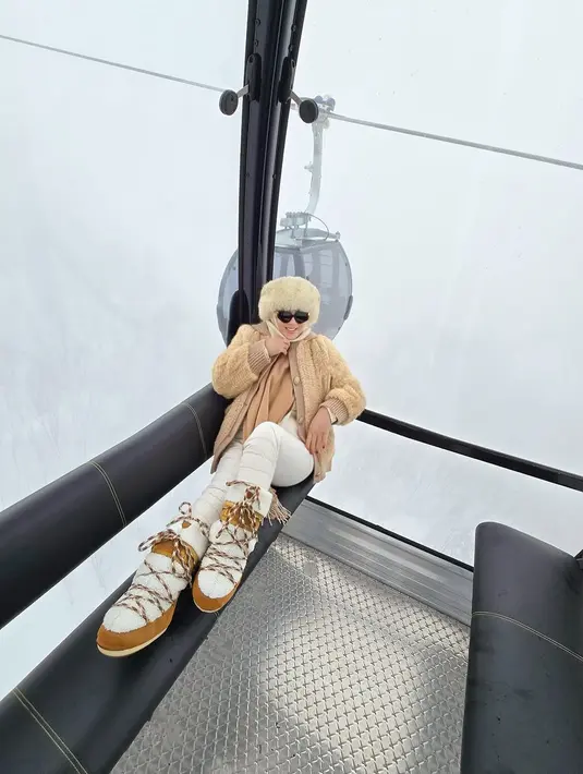 Tetap kenakan hijab, Syahrini kenakan Ushanka cokelat muda dan sepatu boots berbulu tebal [@princessyahrini]