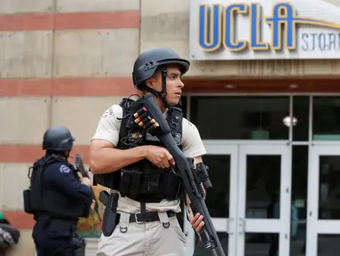 Seorang petugas bersenjata laras panjang mengamankan Universitas California Los Angeles (UCLA) di California, Rabu (1/6). UCLA ditutup sementara setelah terjadi penembakan di satu laboratorium teknik yang menewaskan dua orang. (REUTERS/Patrick T. Fallon)