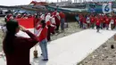 Suasana Upacara Peringatan HUT RI ke-77 di Kawasan Kalibaru Barat, Cilincing, Jakarta, Rabu (17/8/2022). Memperingati Hari Kemerdekaan Indonesia ke-77, anak-anak yang tergabung dalam Kelas Jurnalis Cilik bersama para relawan melaksanakan upacara bendera dan beragam lomba. (Liputan6.com/Helmi Fithriansyah)