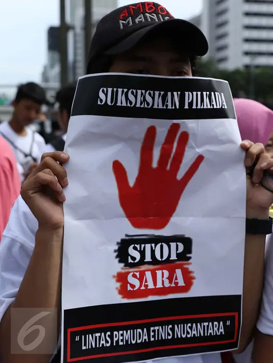 Poster yang dibawa massa Lintas Pemuda Etnis Nusantara saat aksi di Bundaran HI, Jakarta, Minggu (10/9). Mereka mengajak warga agar tidak menggunakan isu SARA untuk menyukseskan Pilkada. (Liputan6.com/Gempur M Surya)
