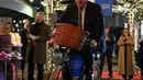 Perdana Menteri Inggris Boris Johnson mengendarai sepeda saat kunjungannya ke pasar Makanan dan Minuman Inggris yang didirikan di Downing Street, London, 30 November 2021. Sebanyak 12 bisnis dari seluruh Inggris memiliki kios untuk memamerkan produk mereka. (JUSTIN TALLIS/AFP/POOL)