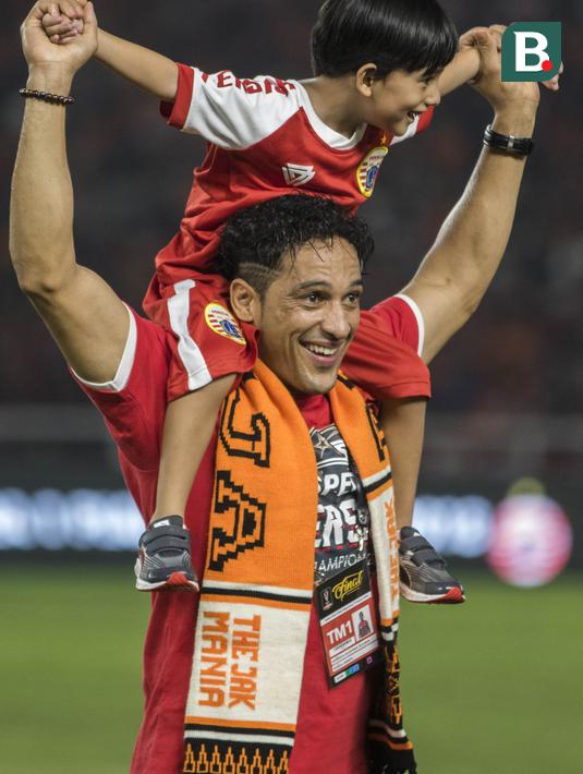 Striker Persija Jakarta, Addison Alves, menggendong sang putra merayakan gelar juara Piala Presiden di SUGBK, Jakarta, Sabtu (17/2/2018). Persija menang 2-0 atas Bali United. (Bola.com/Vitalis Yogi Trisna)