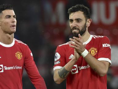 Manchester United berhasil memetik poin penuh saat menjamu Brighton pada laga lanjutan Liga Inggris di Old Trafford, Rabu (16/02/2022) dini hari WIB. Duo Portugis, Cristiano Ronaldo dan Bruno Fernandes masing-masing mencetak gol kemenangan Setan Merah. (Foto kolase: AP/Rui Viera)