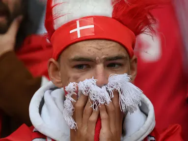 Teriakan dukungan semangat sekejap berubah menjadi raut sedih dan cemas dari pendukung Denmark ketika dikejutkan dengan insiden Christian Eriksen yang tiba-tiba jatuh tak sadarkan diri pada menit ke-43. (Foto: AFP/Pool/onathan Nackstrand)