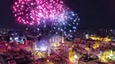 Kembang api menghiasi langit diatas Masjid Mohammad al-Amin saat acara peresmian menyalakan lampu pohon natal di Beirut, Lebanon (10/12). Menyambut datangnya natal, warga Beirut merayakan peresmian pohon natal. (AFP Photo/Stringer)