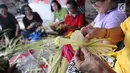 Sejumlah ibu serati banten mempersiapkan Gebogan yang akan digunakan dalam upacara Mecaru dalam menyambut perayaan hari Raya Nyepi dan Tahun baru Saka 1941 di Pura Tribhuana Agung Sukmajaya Depok, Jawa Barat, Selasa (5/3). (Liputan6.com/Herman Zakharia)