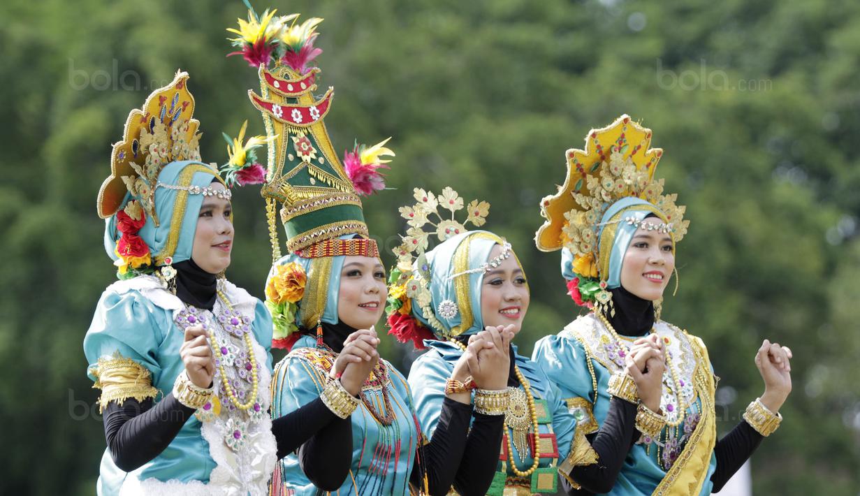 Mahasiswi Universitas Negeri Makassar (UNM) membawakan tarian tradisional pada laga Torabika Campus Cup 2017 di Stadion UNM, Makassar, Kamis, (19/10/2017). UNM berhasil menjadi juara ke tiga pada ajang tersebut. (Bola.com/M Iqbal Ichsan)