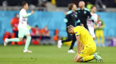 Reaksi pemain Ukraina Illya Zabarnyi usai menghadapi Austria pada pertandingan Grup C Euro 2020 di Stadion National Arena, Bucharest, Rumania, Senin (21/6/2021). Ukraina kalah 0-1. (Marko Djurica/Pool via AP)