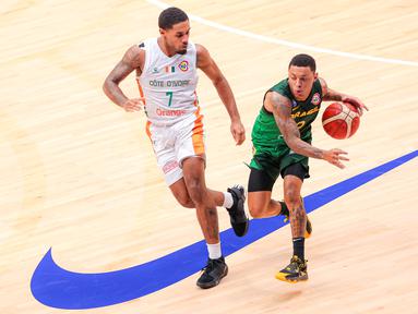 Pebasket Brasil, Yago Santos (kanan) berusaha melewati penjagaan pebasket Pantai Gading, Maxence Dadiet pada laga ketiga Grup G Piala Dunia FIBA 2023 di Indonesia Arena, Senayan, Jakarta, Rabu (30/08/2023). Brasil menang dengan skor 89-77. (Bola.com/Bagaskara Lazuardi)