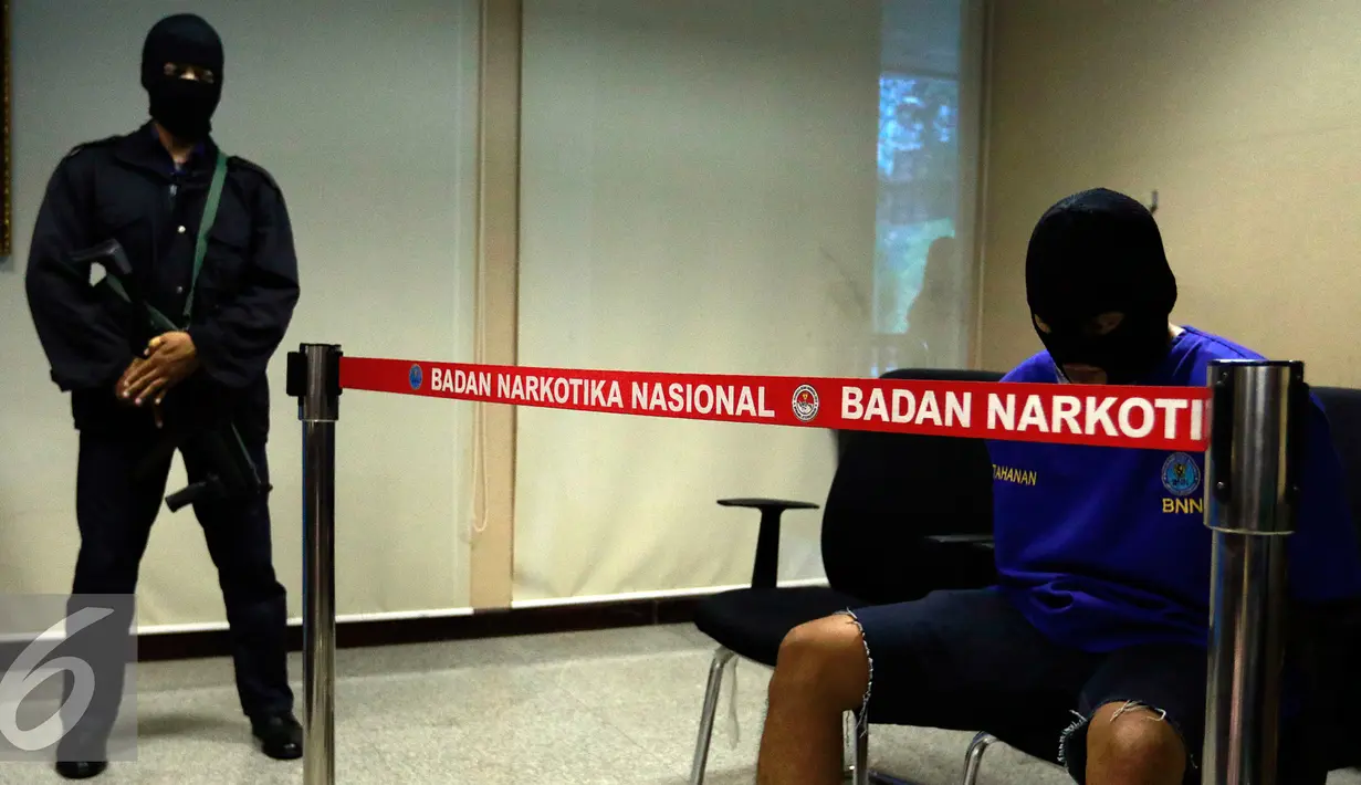 Tersangka AR yang menjadi kurir dihadirkan dalam rilis di kantor BNN, Jakarta, Selasa (27/10/2015). BNN mengamankan empat tersangka kasus narkoba dengan barang bukti 1000 butir pil ekstasi, dua diantaranya merupakan oknum TNI. (Liputan6.com/Yoppy Renato)