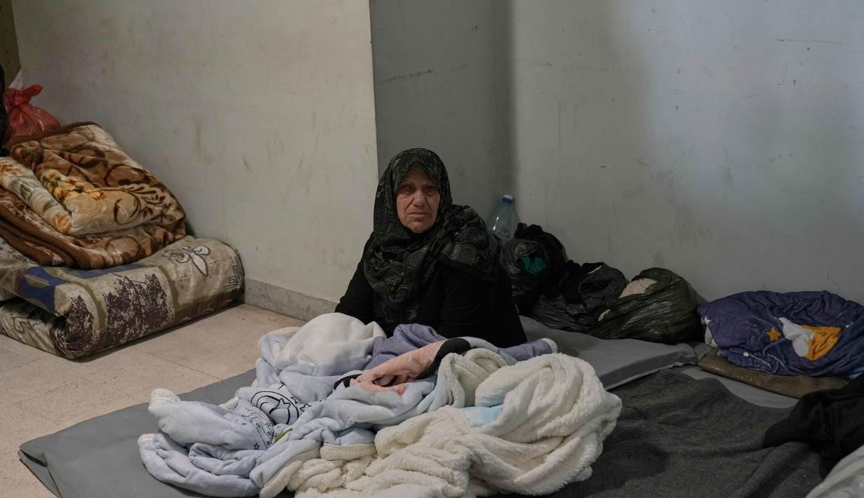 Diketahui, ketegangan di beberapa kawasan selatan Beirut meningkat setelah militer Israel memerintahkan warga untuk mengungsi. Tampak dalam foto, seorang pengungsi wanita lanjut usia yang menghindari serangan udara Israel di Lebanon selatan dan Dahiyeh, beristirahat di Institut Teknik Bir Hassan yang telah diubah menjadi tempat penampungan, Beirut, Rabu 11 Maret 2026. (AP Photo/Bilal Hussein)