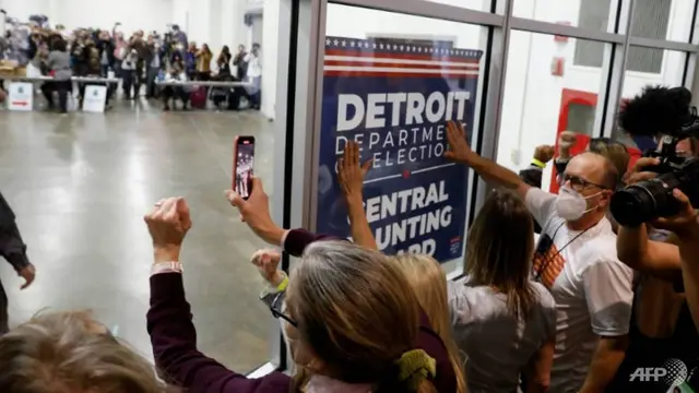 Pendukung Presiden AS Donald Trump menggedor kaca dan meneriakkan slogan-slogan di luar ruangan tempat surat suara yang absen untuk pemilihan umum 2020 dihitung pada 4 November 2020 di Detroit. (Foto: AFP / Jeff Kowalsky)
