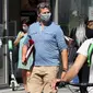 Orang-orang memakai masker saat berjalan di Brussel, Belgia, Rabu (12/8/2020). Penggunaan masker menjadi wajib di tempat umum di Brussel karena kasus Covid-19 naik ke tingkat kewaspadaan yang menempatkan kota itu di antara yang paling parah terkena dampak corona di Eropa. (François WALSCHAERTS/AFP)