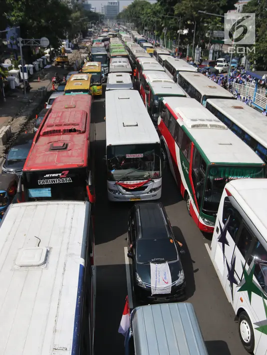 Suasana di Jalan Medan Merdeka Timur saat dipadati puluhan bus yang mengangkut buruh, Jakarta, Selasa (1/5). Berdasarkan data kepolisian, sekitar 30 ribu buruh melakukan aksi May Day 2018 di Jakarta. (Liputan6.com/Arya Manggala)