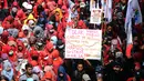 Massa buruh mengacungkan pamplet di ruas Jalan Medan Merdeka Barat saat perayaan hari Buruh Internasional di Kawasan Patung Patung Arjuna Wiwaha, Jakarta, Senin (5/1). Ribuan massa buruh ikut dalam perayaan MayDay 2017. (Liputan6.com/Helmi Fithriansyah) 