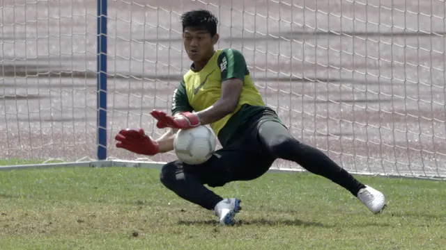 Kiper Timnas Indonesia U-22, Muhammad Riyandi, menahan bola saat latihan. (Bola.com/Yoppy Renato)