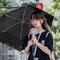 Seorang wanita menggunakan payung untuk berlindung dari sinar matahari saat berjalan di sepanjang jalan di Tokyo pada 19 September 2024. (Yuichi YAMAZAKI/AFP)