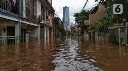 Suasana banjir yang merendam permukiman warga di kawasan Kebalen, Jakarta, Sabtu (20/2/2021). Curah hujan yang tinggi menyebabkan banjir setinggi orang dewasa di kawasan Kebalen. (Liputan6.com/Johan Tallo)