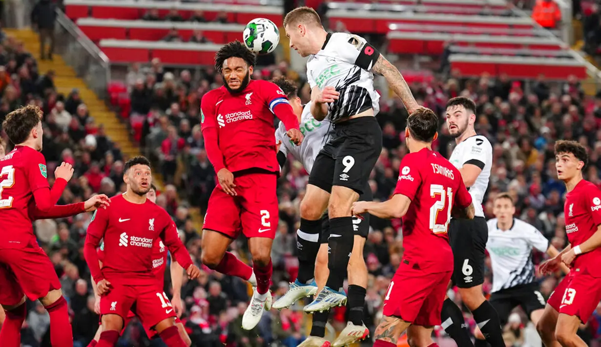 Pemain Derby County James Collins (tengah kanan) menyundul bola melewati pemain Liverpool Joe Gomez (tengah kiri) pada pertandingan sepak bola Piala Liga Inggris atau Carabao Cup di Stadion Anfield, Liverpool, Inggris, 9 November 2022. Liverpool  menyingkirkan Derby County lewat adu penalti dengan skor 3-2. (AP Photo/Jon Super)