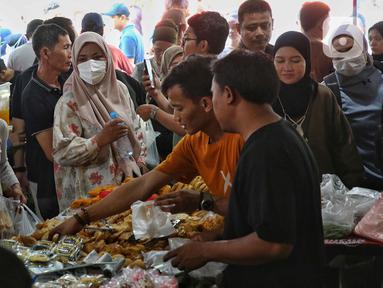 Warga memilih ragam aneka takjil untuk berbuka puasa yang dijajakan di Pasar Takjil Ramadan Bendungan Hilir (Benhil), Jakarta, Minggu (2/3/2025). (Liputan6.com/Angga Yuniar)