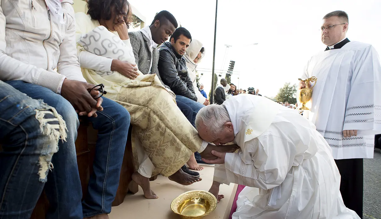 Paus Fransiskus mencium kaki imigran sebelum memimpin misa Kamis Putih, di sebuah lokasi penampungan di Castelnuovo, dekat Roma, Italia, Kamis (24/3/2016). (Reuters/ Osservatore Romano)