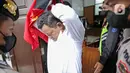 Terdakwa kasus pembunuhan Brigadir Nopriansyah Yosua Hutabarat atau Brigadir J, Kuat Ma'ruf usai menjalani sidang lanjutan di Pengadilan Negeri Jakarta Selatan, Jakarta, Rabu (26/10/2022). Dalam sidang tersebut hakim menolak eksepsi Kuat Ma'ruf. (Liputan6.com/Faizal Fanani)