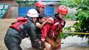 Petugas penyelamat membantu warga saat banjir melanda kawasan Guilin, provinsi Guangxi (3/7). Banjir di Cina selatan telah menewaskan sedikitnya 15 orang selama beberapa hari terakhir dan memaksa ribuan orang mengungsi. (AFP Photo/Str/China Out)
