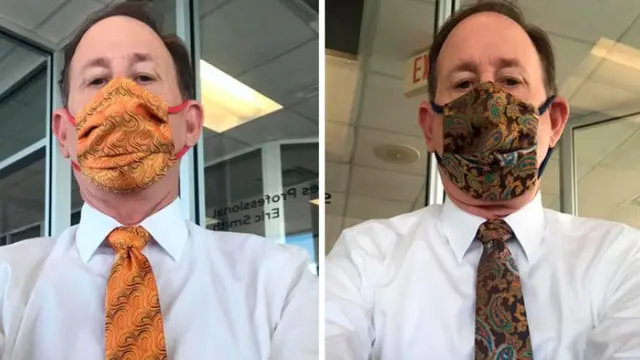 Pria kenakan motif masker dan dasi yang sama