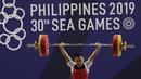 Lifter Eko Yuli melakukan angkatan saat SEA Games 2019 cabang angkat besi nomor 61 kg di Stadion Rizal Memorial, Manila, Minggu (1/12). Dirinya meraih emas dengan total angkatan 309 kg. (Bola.com/M Iqbal Ichsan)