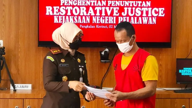 Kepala Kejari Pelalawan Silpia Rosalina saat menyerahkan surat penghentian perkara pencurian sawit.