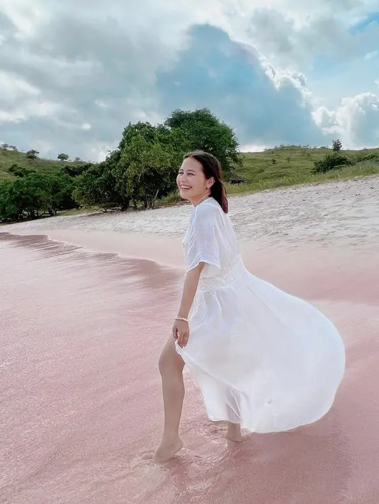 Prilly tampil dengan outer panjang warna putih dengan dalaman baju renang, dilengkapi aksesori gelangnya.  (@prillylatuconsina96)